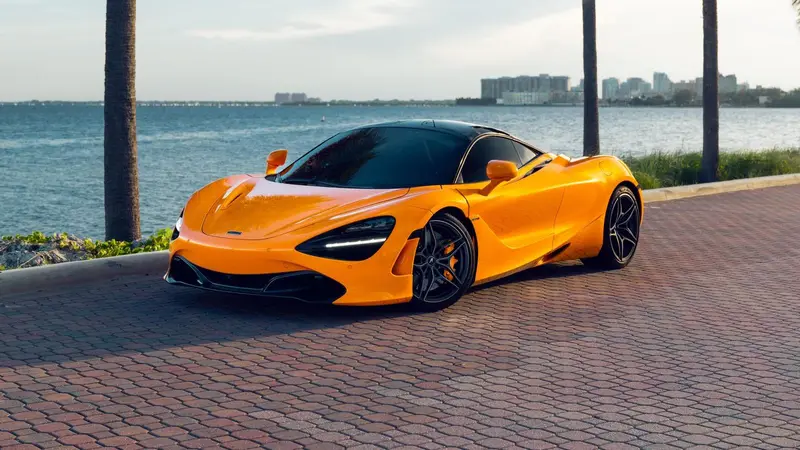Orange McLaren 720S on a Miami waterfront road