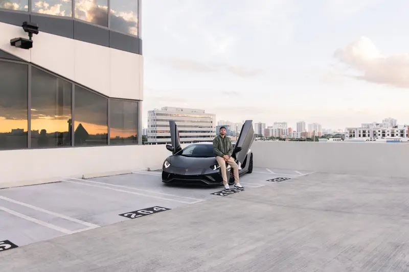 Rushing Rentals — exotic cars on a Miami rooftop at sunset