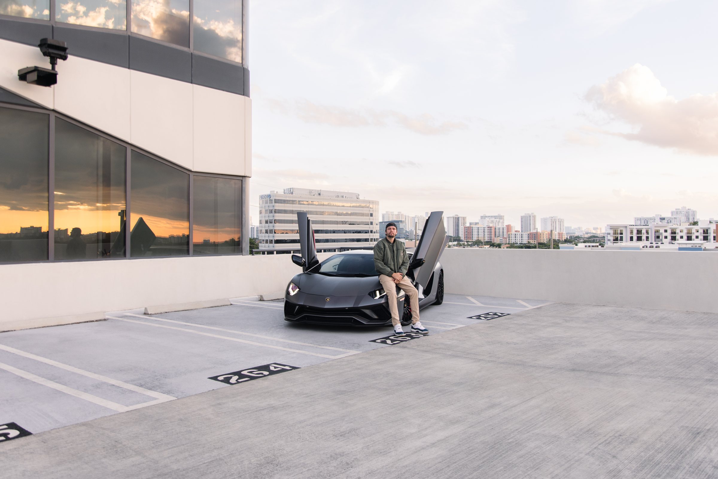 Rushing Rentals — exotic cars on a Miami rooftop at sunset